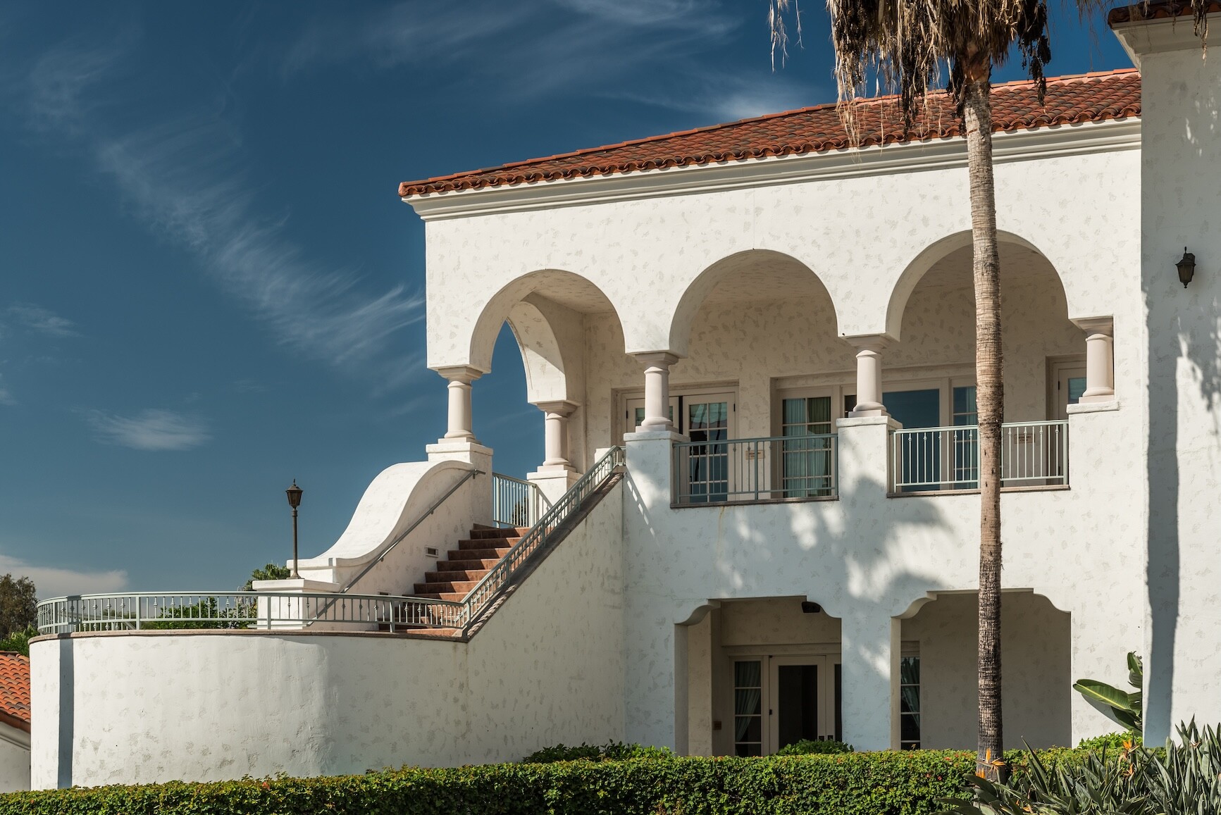 White building with stairs and a palm tree 2026 03 18 16 02 36 utc